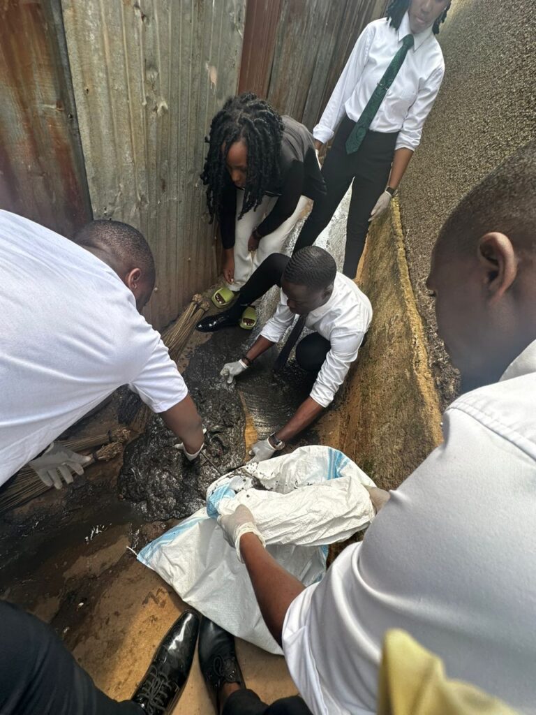 Juma Wasswa BALUNYWA and his campaign team cleaning MUBS campus